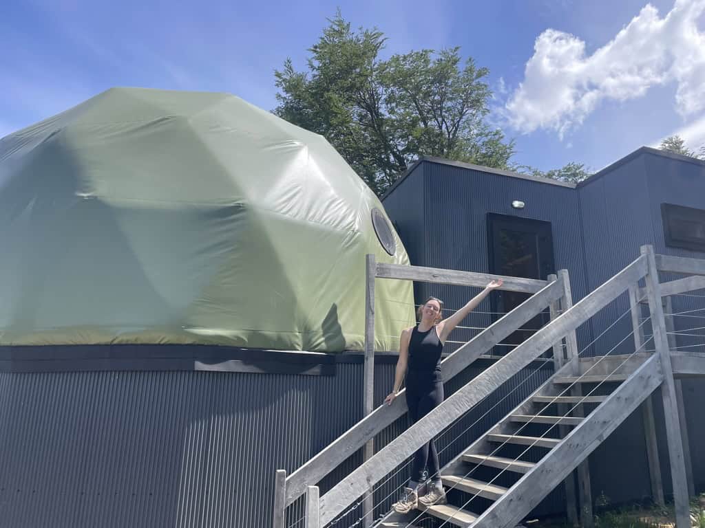 female outside green roof dome bubble hut at Frances lodge in Patagonia on a two week trip