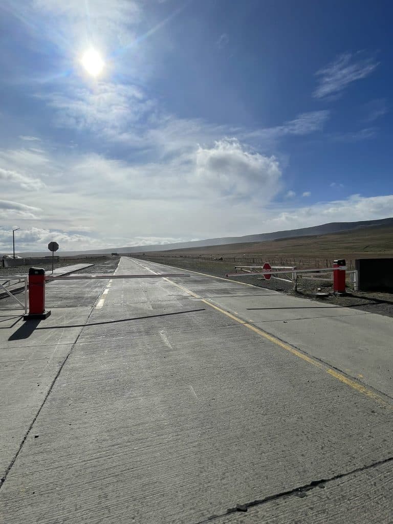 border crossing in Patagonia, paved road with two small white plastic arms