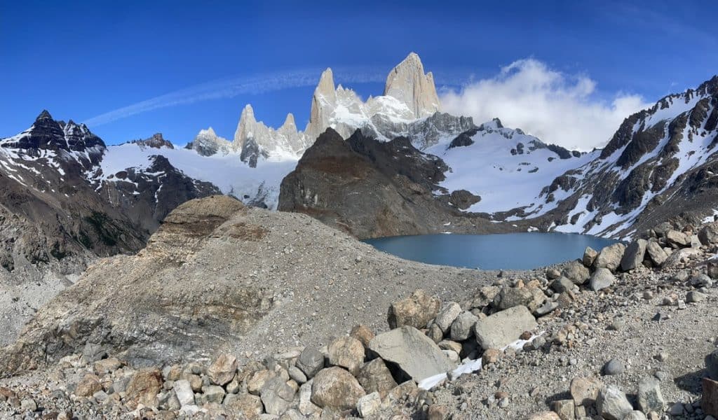 Summit view of Laguna del Los Tres in Patagonia with three peaks of mountains, rocks and glacial lake