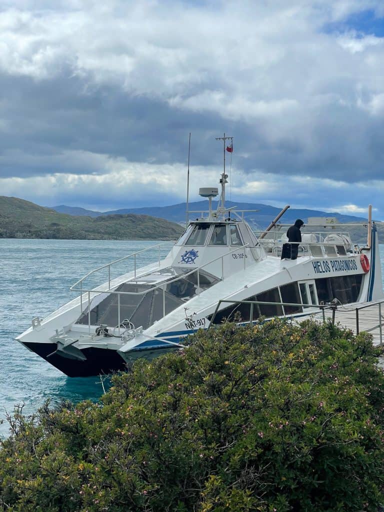 picture of small boat ferry white in colour with blue writing in patagonia