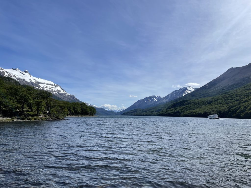 Lago del Diserto lake with dark blue waters and snow capped mountains