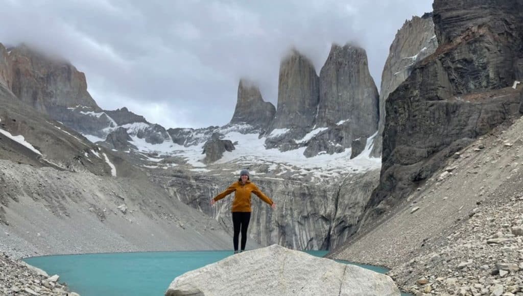 Hiker at the summit of Mirador Las Torres Base in Patagonia, Chile